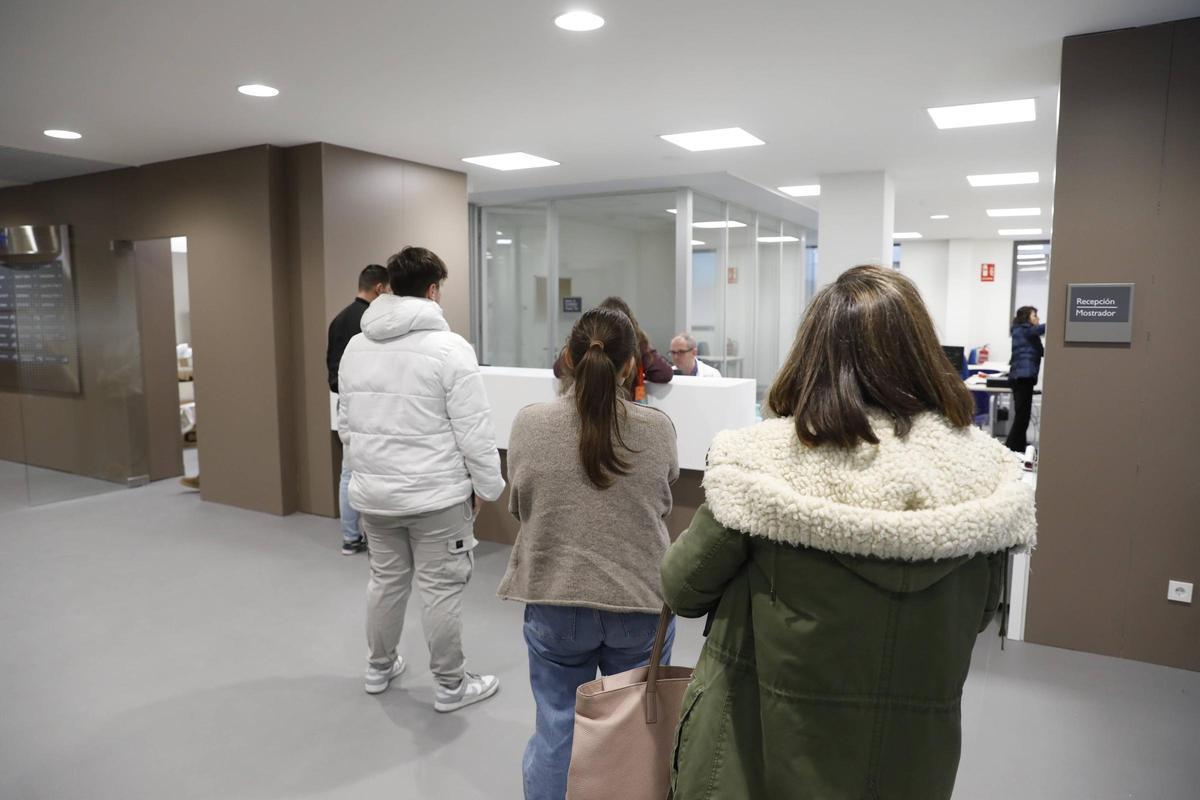 Pacientes ante el mostrador el primer día de activiad en el centro de salud de Sotrondio