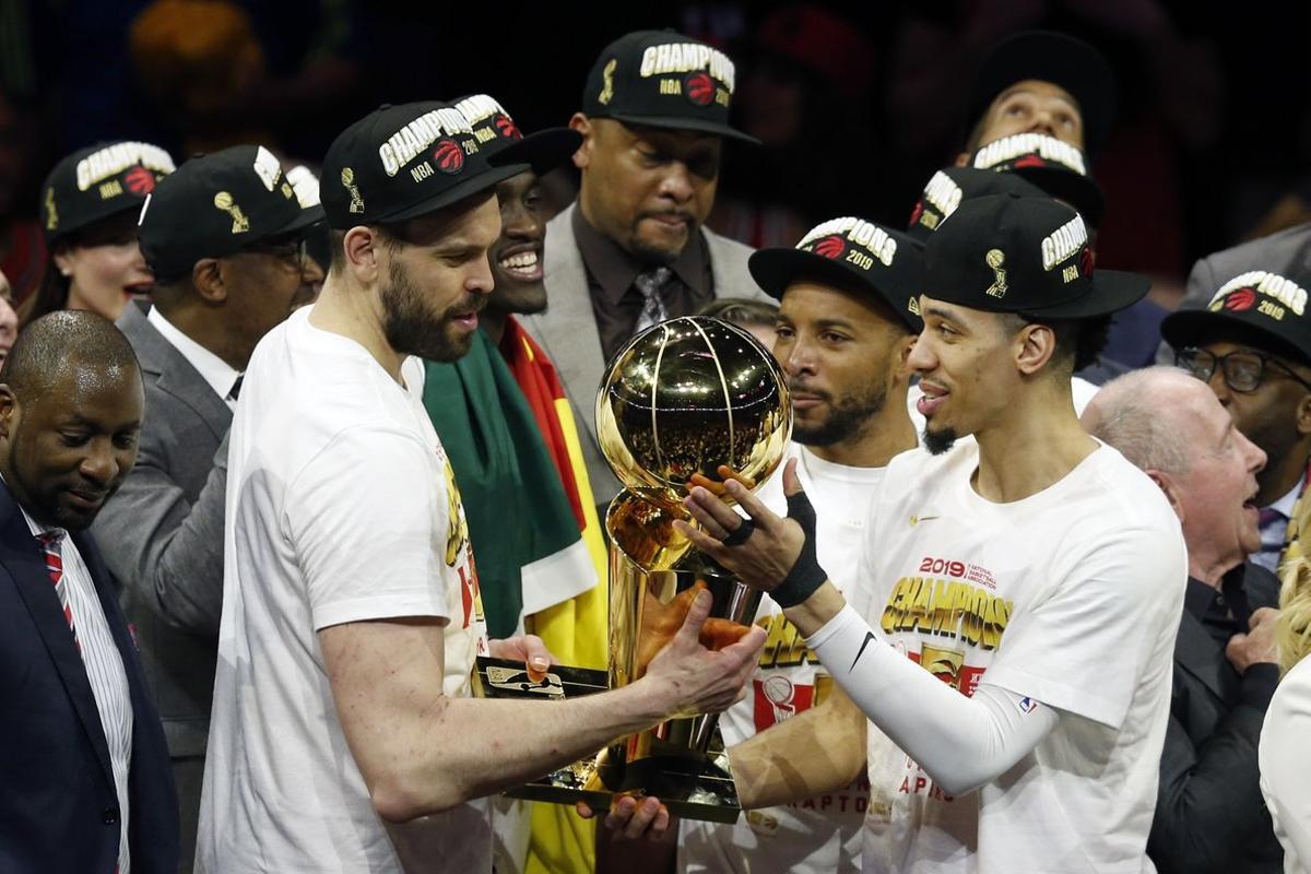 OAKLAND, CALIFORNIA - JUNE 13: Marc Gasol #33 and Danny Green #14 of the Toronto Raptors celebrate with the Larry O’Brien Championship Trophy after his team defeated the Golden State Warriors to win Game Six of the 2019 NBA Finals at ORACLE Arena on June 13, 2019 in Oakland, California. NOTE TO USER: User expressly acknowledges and agrees that, by downloading and or using this photograph, User is consenting to the terms and conditions of the Getty Images License Agreement.   Lachlan Cunningham/Getty Images/AFP