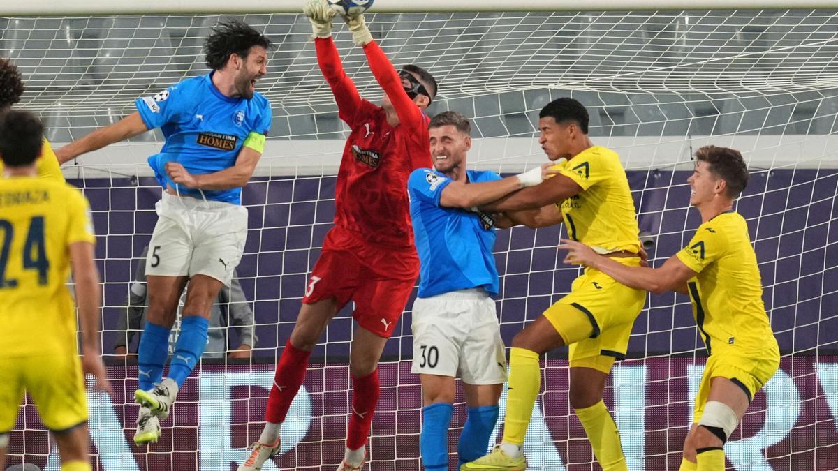 Pafos' goalkeeper Neofytos Michail, center, saves the ball during the Champions League opening phase soccer match between Pafos FC and Villarreal CF in Limassol, Cyprus, Wednesday, Nov. 4, 2025. (AP Photo/Petros Karadjias)