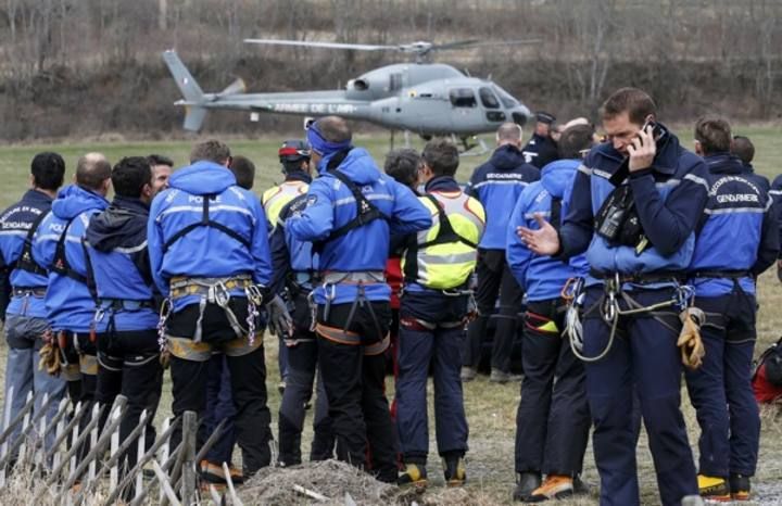 French Police and Gendarmerie Alpine rescue units gather on a field as they prepare to reach the crash site of an Airbus A320