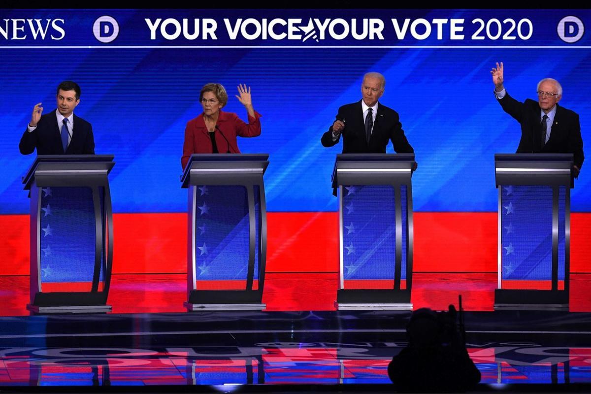 TOPSHOT - (From L) Democratic presidential hopefuls former Mayor of South Bend, Indiana, Pete Buttigieg, Massachusetts Senator Elizabeth Warren, former Vice President Joe Biden and Vermont Senator Bernie Sanders gesture during the eighth Democratic primary debate of the 2020 presidential campaign season co-hosted by ABC News, WMUR-TV and Apple News at St. Anselm College in Manchester, New Hampshire, on February 7, 2020. (Photo by Timothy A. CLARY / AFP)