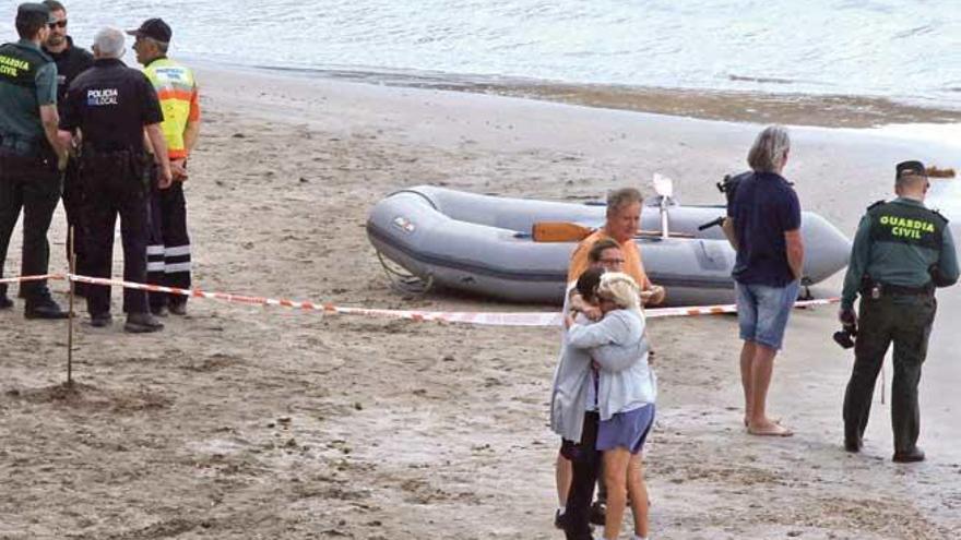 Familiares de la víctima se abrazan en la costa mientras buscaban al pescador desaparecido.