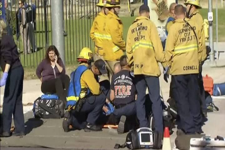 Still from video shows rescue crews tending to the injured in the intersection outside the Inland Regional Center in San Bernardino