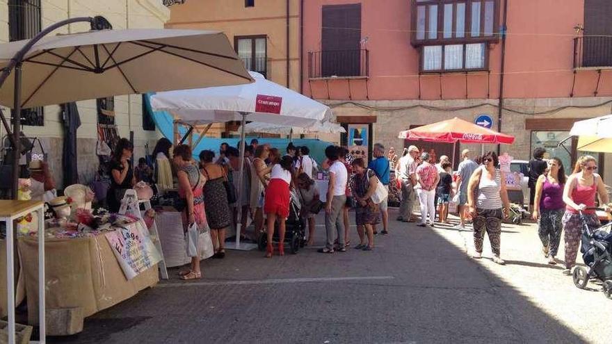 Varias personas visitan el mercado artesanal de tendencias.