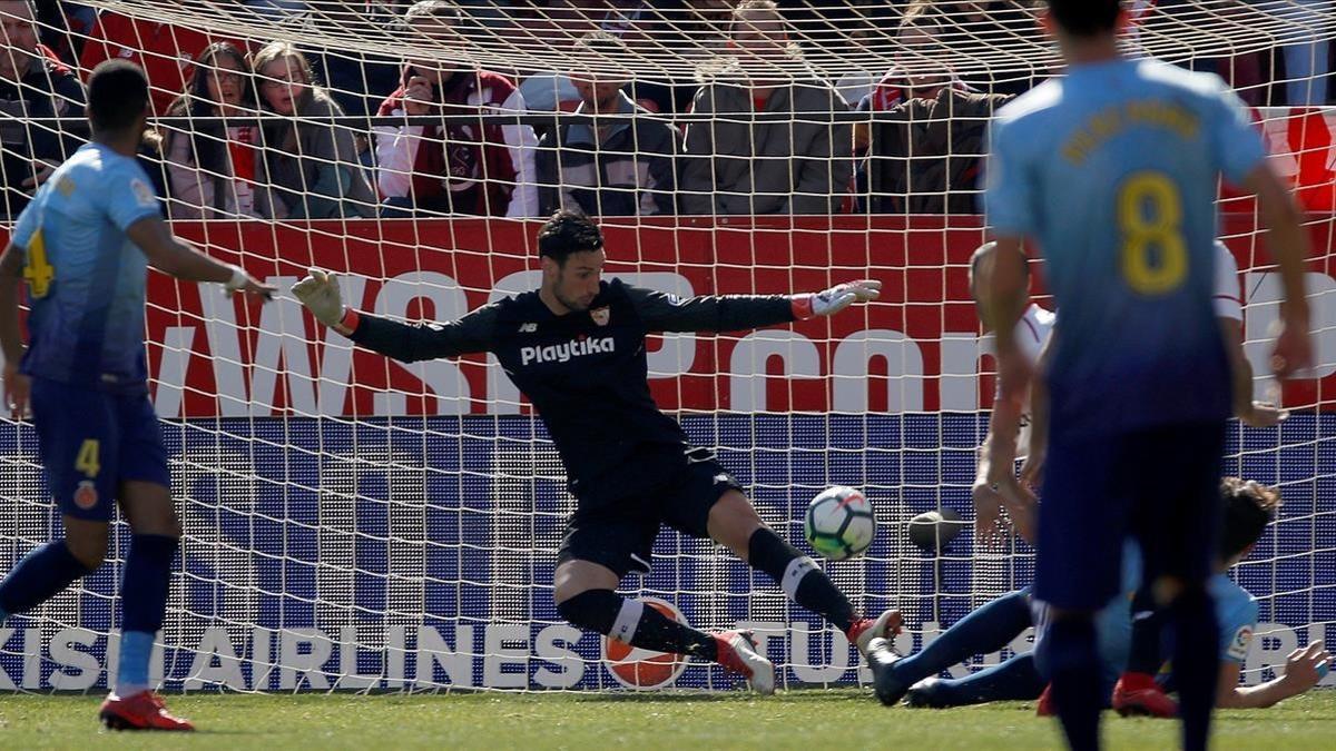 El portero del Sevilla Sergio Rico saca un balón al central del Girona Bernardo Espinosa.