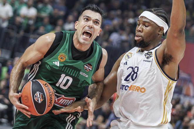 Kostas Sloukas of Panathinaikos Athens, left, against Madrids Guerschon Yabusele in action during the Euroleague final round, Final Four, Final between Real Madrid and Panathinaikos Athens at the Uber Arena in Berlin, Sunday May 26, 2024. (Andreas Gora/dpa via AP) / GERMANY OUT; MANDATORY CREDIT