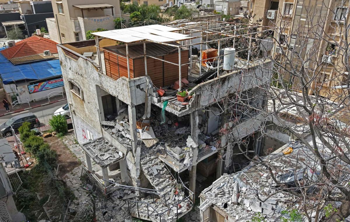 This aerial photograph shows the damaged building that was hit by an Iranian strike in a residential neighbourhood in Ramat Gan on April 4, 2026. The Israeli army said on April 4 its air defences were working to down missiles fired from Iran, which medics reported wounded one person. (Photo by Jack GUEZ / AFP) /. SEE CAPTION FOR MORE INFORMATION / Attention editors: AFP covers the war in the Middle East through its extensive regional network, including bureaus in Tehran, Jerusalem, and several neighboring countries. Since the start of the conflict, journalists have