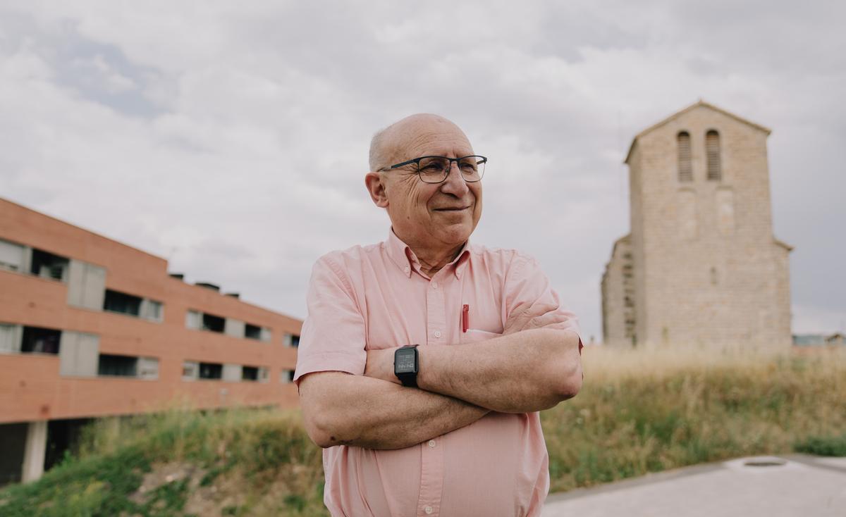 Ángel Ibáñez, uno de los arquitectos de Taller de Ideas, que elaboró el planeamiento de Sarriguren, posa en el pueblo, con la iglesia antigua y un edificio de nueva construcción. 