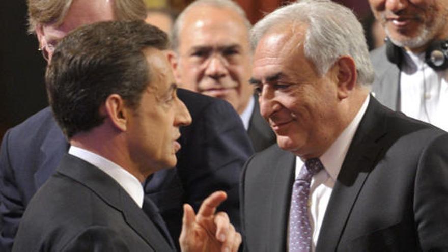 Nicolas Sarkozy saluda a Strauss-Kahn