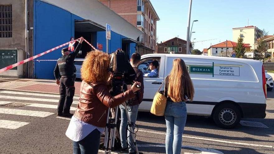 El coche de la funeraria, llegando a Abanto tras el crimen de dos mujeres, madre e hija. // Efe