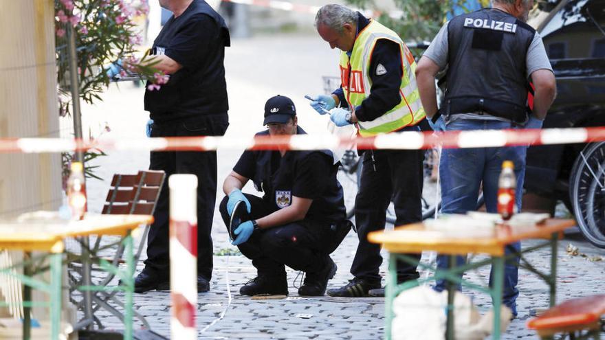 Agentes de Policía, buscando pruebas en el lugar de la explosión. // Reuters