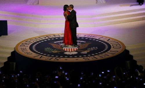 U.S. first lady Michelle Obama kisses U.S. President Barack Obama as they dance at the Commander in Chief's ball in Washington