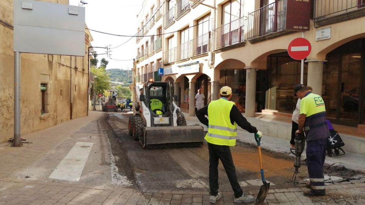 Un grup d’operaris treballant en l’asfaltatge del carrer. | AJUNTAMENT DE CALONGE