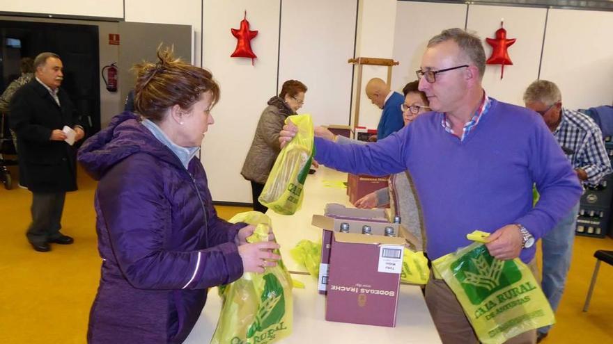 La entrega del bollo y la botella de vino en el hogar del pensionista &quot;El Carmín&quot;, de la Pola.