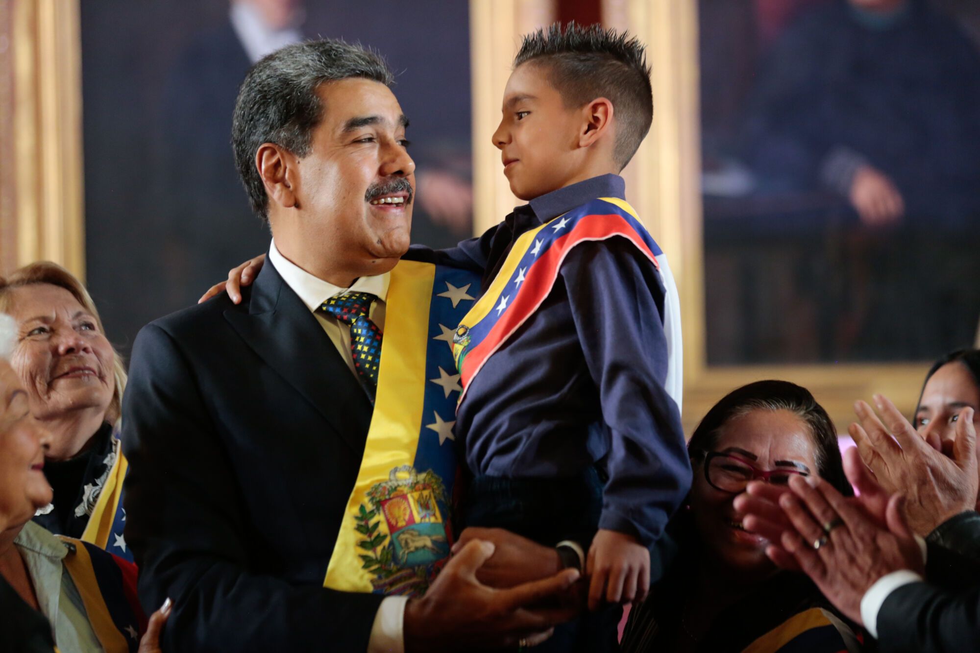 HANDOUT - 10 January 2025, Venezuela, Caracas: Venezuelan President Nicolas Maduro holds a child in his arms after being sworn in for a third term in office. Photo: Milagros Nunez/Prensa Miraflores/dpa - ACHTUNG: Nur zur redaktionellen Verwendung und nur mit vollständiger Nennung des vorstehenden Credits 10/01/2025 ONLY FOR USE IN SPAIN. Milagros Nunez/Prensa Miraflores / DPA;Politics;politics;heads of state;elections;Inauguration of President Nicolas Maduro in Venezuela;