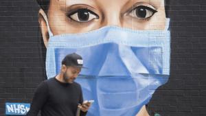 zentauroepp53648696 a man passes a mural depicting a nurse wearing scrubs and fa200606163507