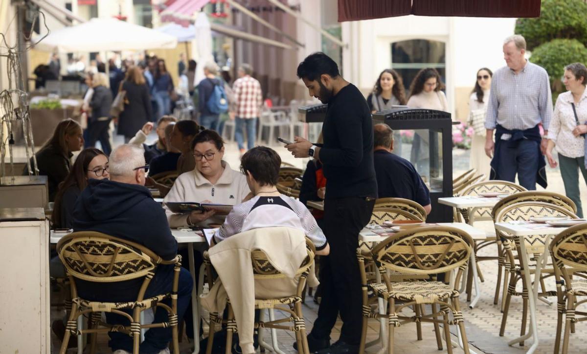 Un camarero en un establecimiento de hostelería en Málaga. | ÁLEX ZEA