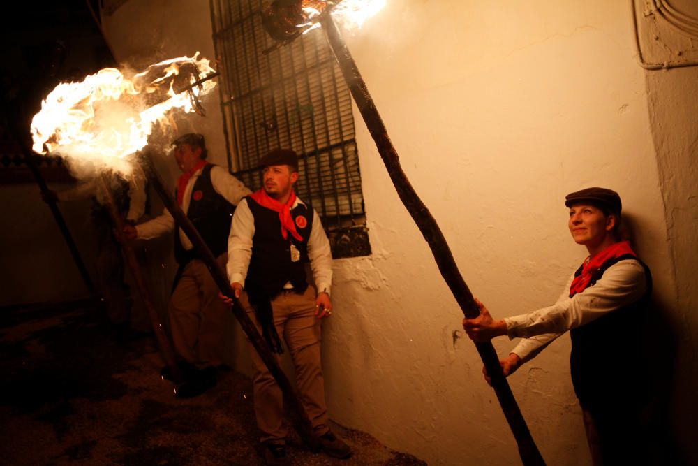 Villagers hold torches during the Divina Pastora ...