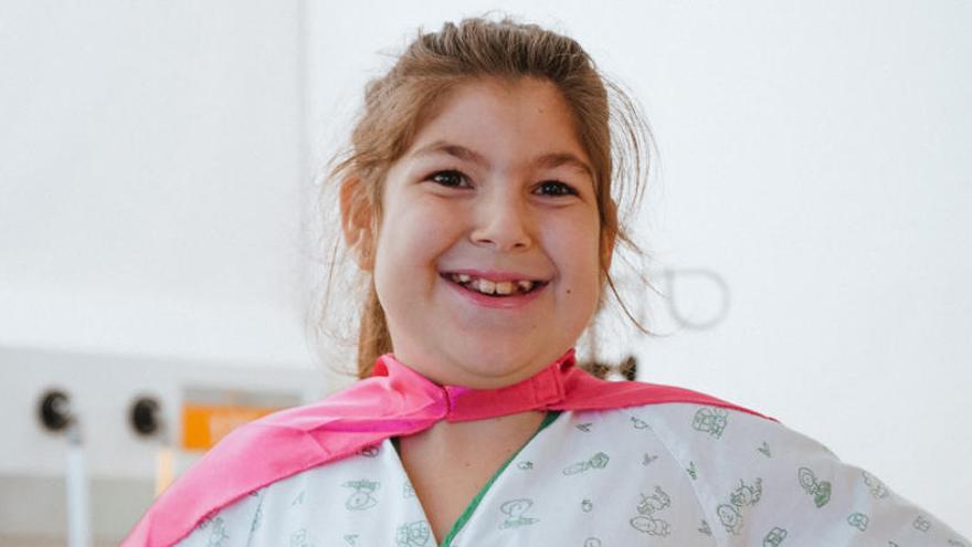 La pequeña Lucía, con una capa, en el hospital.
