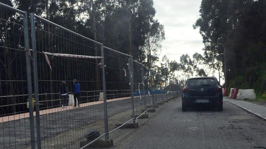 Coches pasando por la zona en obras con el asfalto fresado.