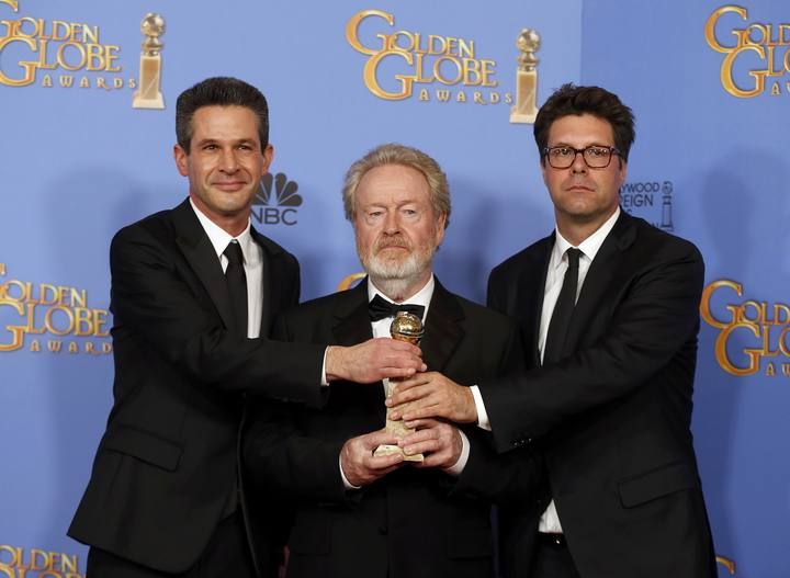 Ridley Scott, Simon Kinberg and Michael Scheafer pose with their award during the 73rd Golden Globe Awards in Beverly Hills