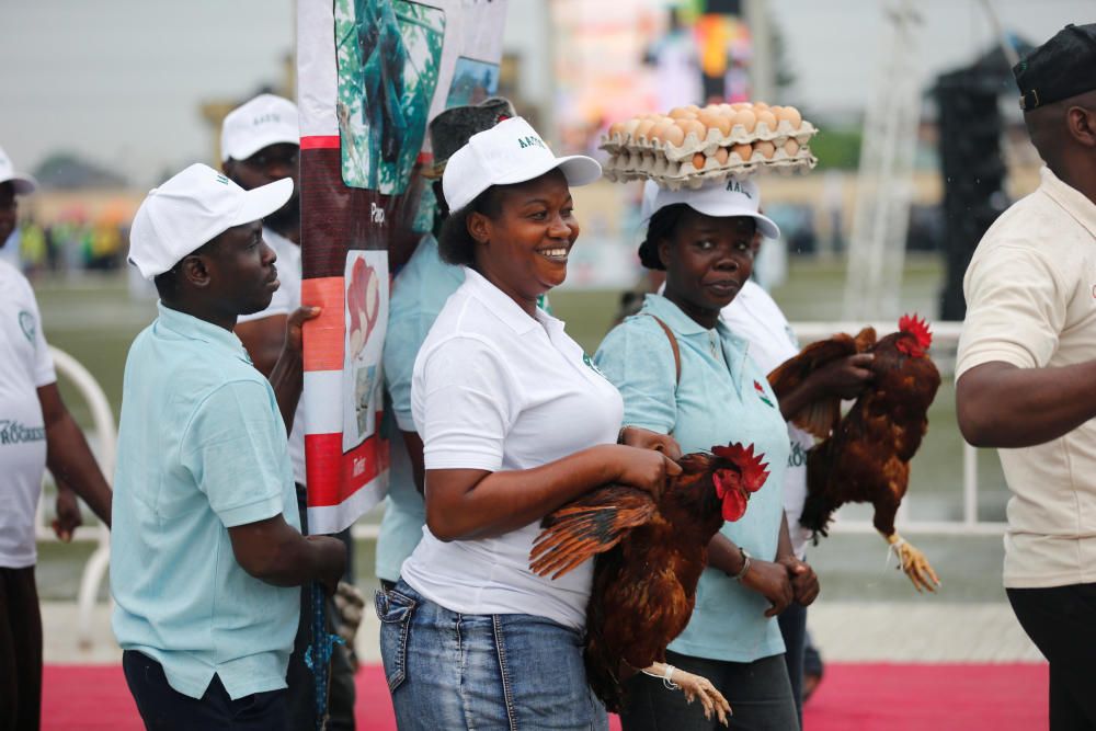 Workers of the agriculture sector march past ...