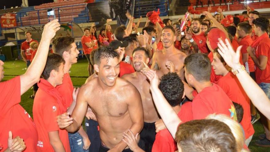 Los jugadores de La Nucía celebran su ascenso sobre el césped del Camilo Cano