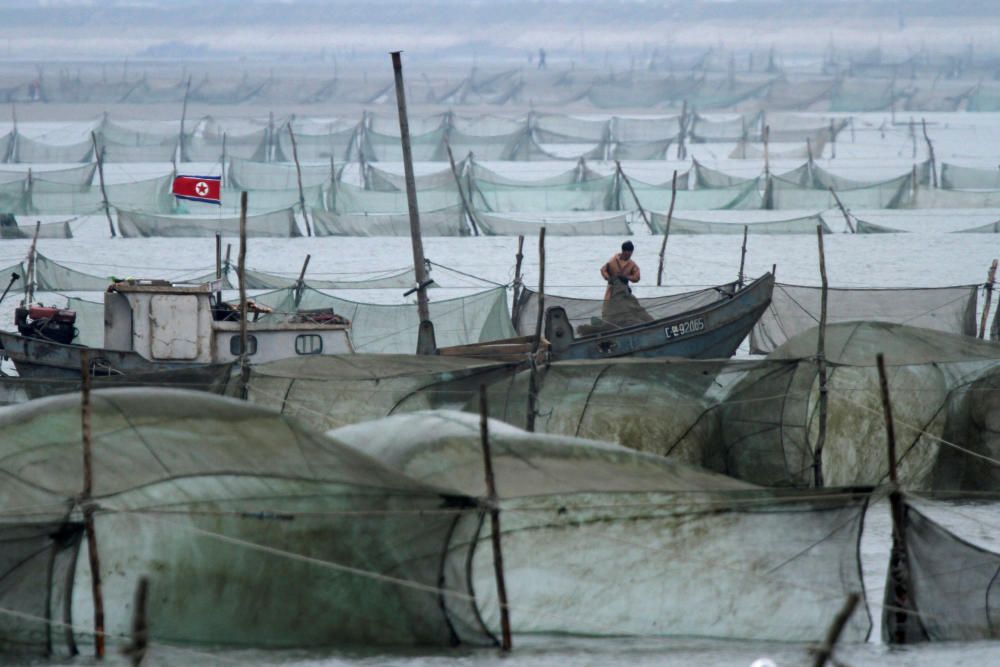 A North Korean fishes on the Yalu River in Sinuiju