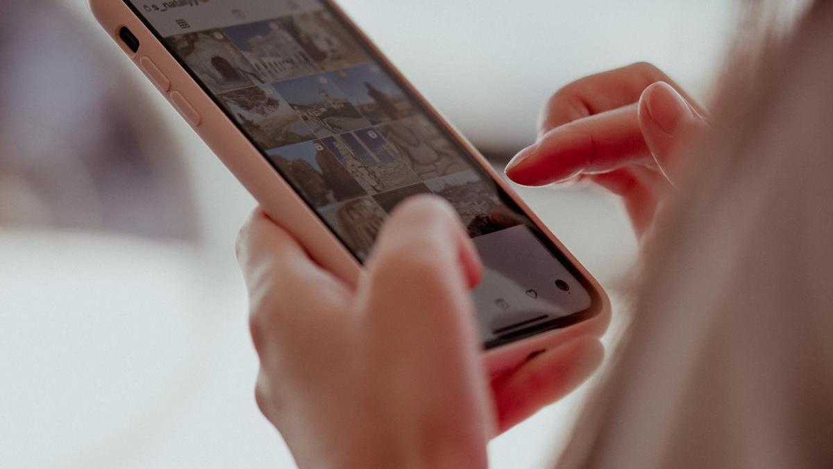 Una mujer navega en Instagram en una foto de archivo.