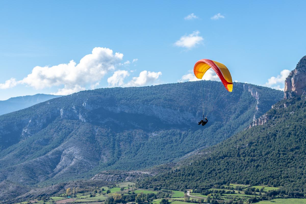 Imagen de archivo de una persona descendiendo en parapente.