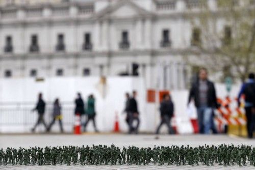 Toy soldiers are seen on the ground as part of an art installation in Santiago