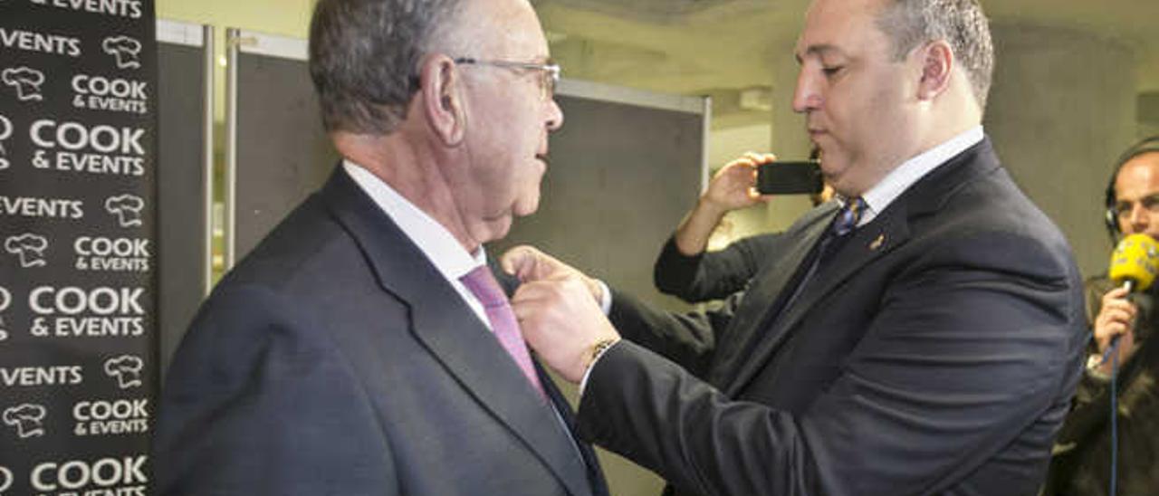 Miguel Ángel Ramírez (d) impone la insignia de oro y brillantes al expresidente Germán Suárez.