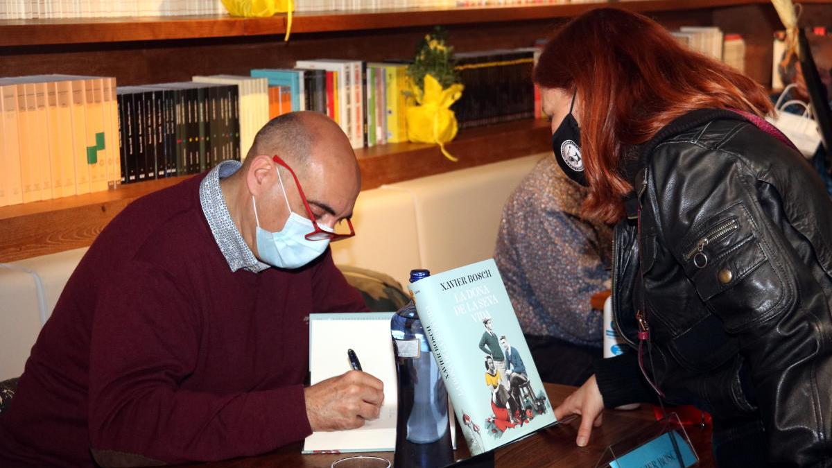 Xavier Bosch signant un dels seus llibres.