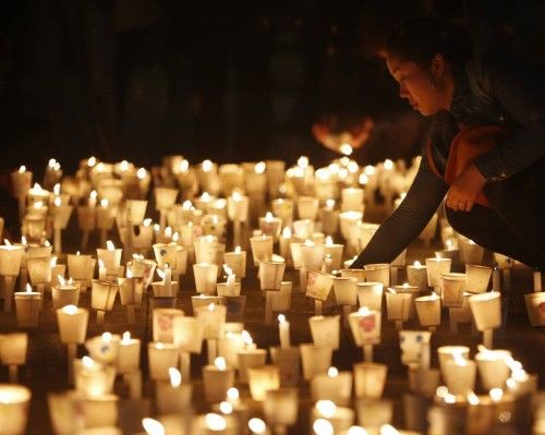 A woman attends a candlelight vigil for capsized South Korean ferry in Ansan