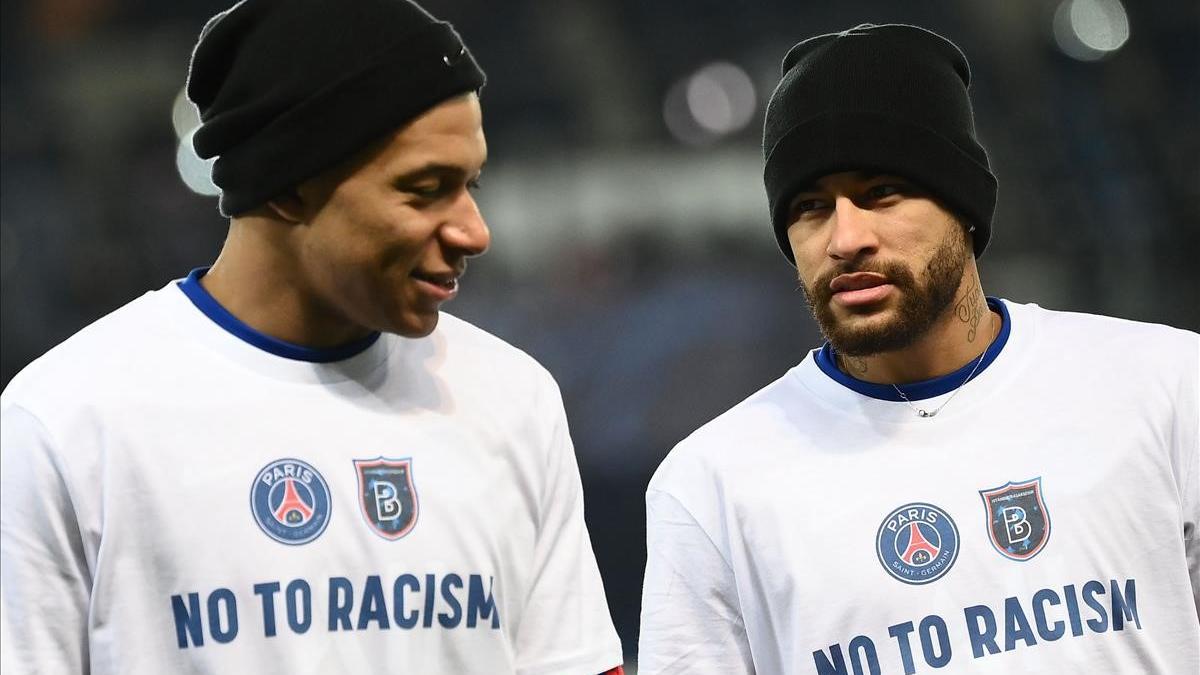 Paris Saint-Germain s French forward Kylian Mbappe (L) and Paris Saint-Germain s Brazilian forward Neymar  wearing tshirt reading  No to racism  warm up before the UEFA Champions League group H football match between Paris Saint-Germain (PSG) and Istanbul Basaksehir FK at the Parc des Princes stadium in Paris  on December 9  2020  - The group game in Paris  which was goalless at the time  was suspended when both teams left the pitch on December 8  2020 after a touchline argument erupted when the Romanian fourth official  Sebastian Coltescu  appeared to describe Basaksehir assistant coach Pierre Webo  a former Cameroon international player  as  black   or  negru  in Romanian and will resume on December 9 where it left off  in the 14th minute  with a different set of officials  (Photo by FRANCK FIFE   AFP)