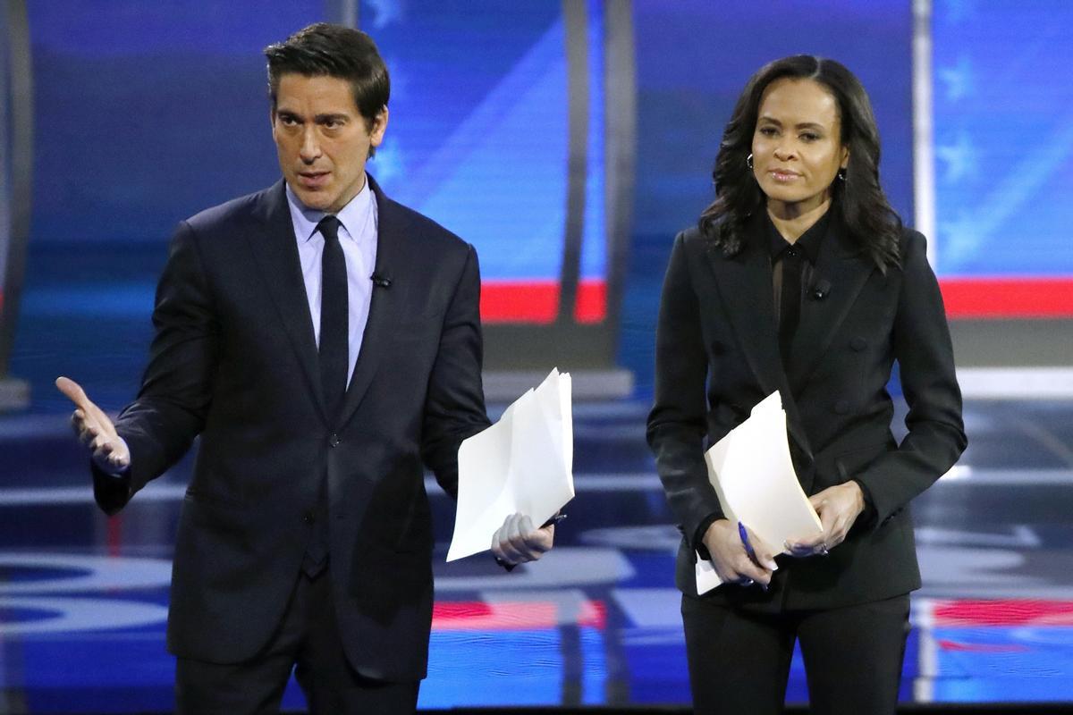 FILE - ABC World News Tonight Anchor David Muir, left, addresses members of the audience while standing with ABC News Live Anchor Linsey Davis, Friday, Feb. 7, 2020 in Manchester, N.H. (AP Photo/Elise Amendola, File) / FILE PHOTO