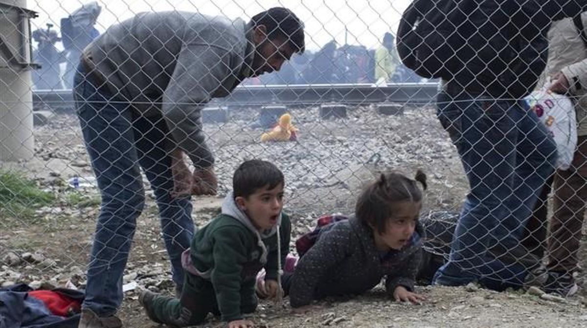 icoy32996048 a man helps children to run away after macedonian 160229160229