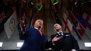 President Donald Trump, left, speaks to reporters on the red carpet as FIFA President Gianni Infantino, right, watches, while arriving to attend the draw for the 2026 soccer World Cup at the Kennedy Center, Friday, Dec. 5, 2025, in Washington. (AP Photo/Julia Demaree Nikhinson)