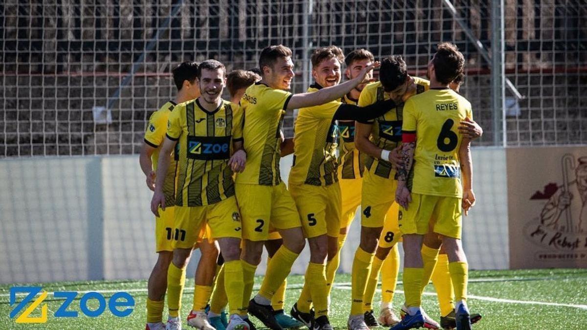 Jugadores del UE Santa Coloma luciendo en sus equipajes el logo de la empresa acusada de estafa piramidal