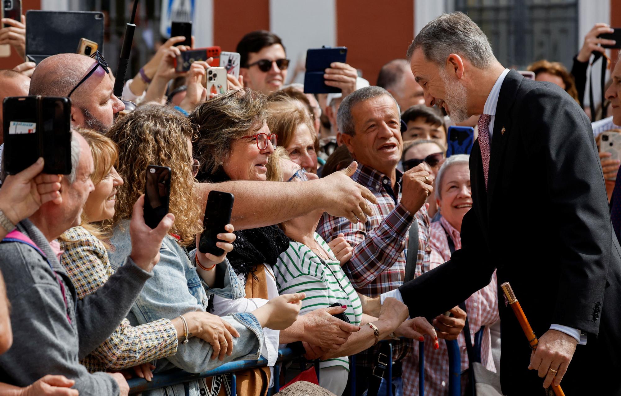 Spain's King Felipe VI waves to the crowd as he arrives to attend the meeting of the five "Real Maestranzas de Caballeria" in Ronda