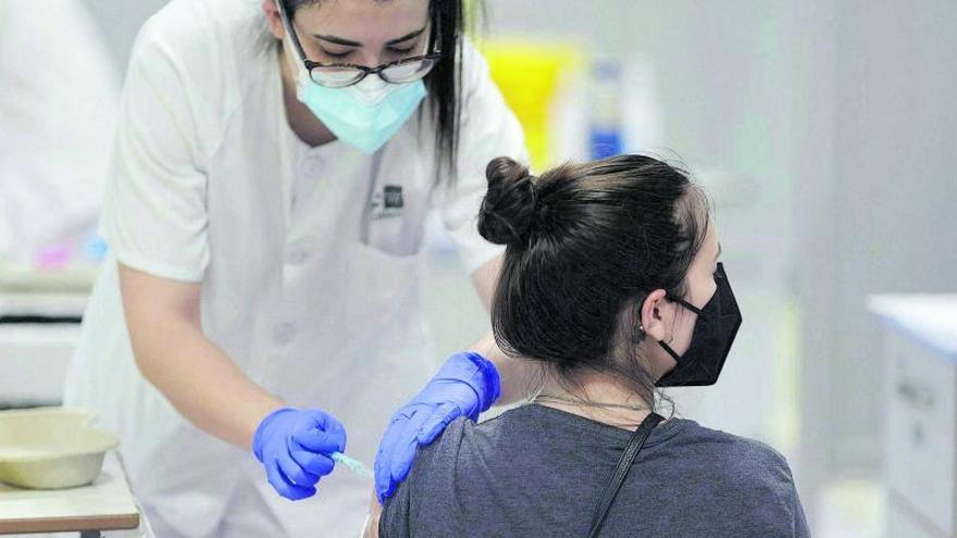 Una enfermera vacuna en Extremadura a una joven contra el coronavirus. |  
 // EDUARDO PARRA