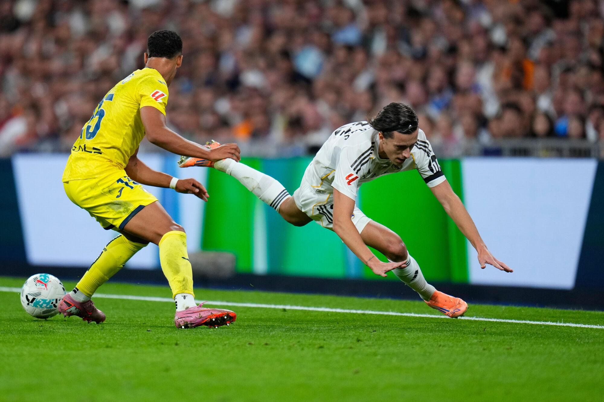 Real Madrid's Alvaro Carreras, right, and Villarreal's Santiago Mourino challenge for the ball during the Spanish La Liga soccer match between Real Madrid and Villarreal at the Santiago Bernabeu stadium in Madrid, Spain, Saturday, Oct. 4, 2025. (AP Photo/Manu Fernandez)