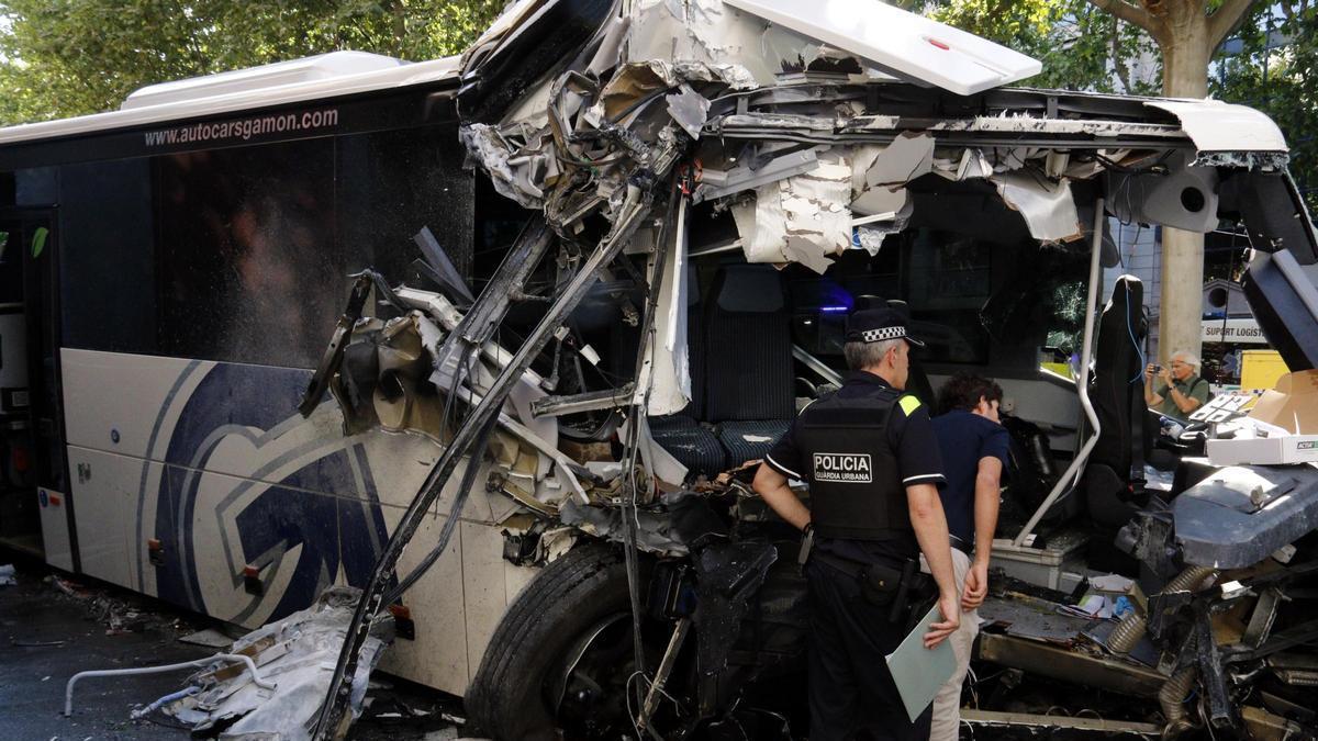 Agents de la Guàrdia Urbana de Lleida inspeccionen l'autocar accidentat a la rambla de Ferran de Lleida.