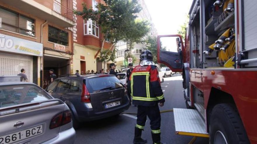 Los bomberos y la Policía Municipal, ayer junto al edificio en el que se originó el fuego.