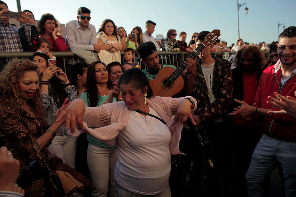 Roma people sing and dance as they take part in ...