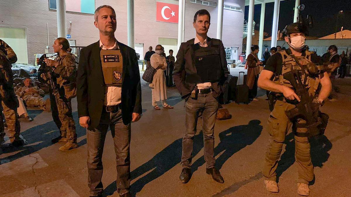 A la izquierda de la imagen, el embajador francés en Afganistán, David Martinon, espera a los ciudadanos franceses y afganos en el aeropuerto de Kabul.