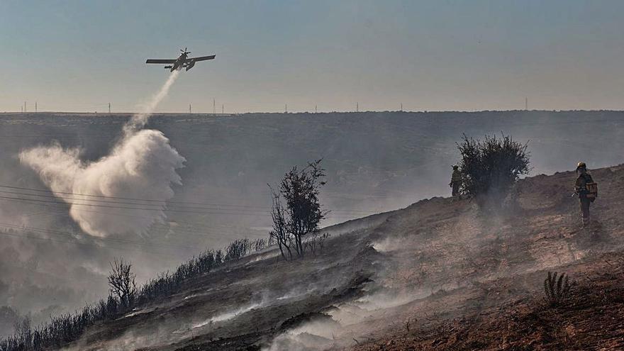 El avión de Rosinos descarga agua sobre la zona afectada por el incendio. | Emilio Fraile