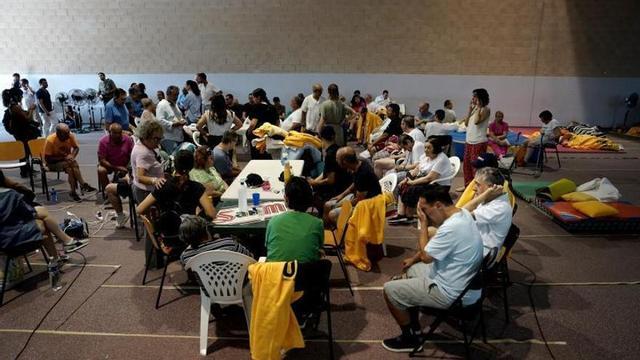 Veïns reallotjats al poliesportiu municipal de Villamanta (Madrid), procedents de localitats desallotjades pels incendis.