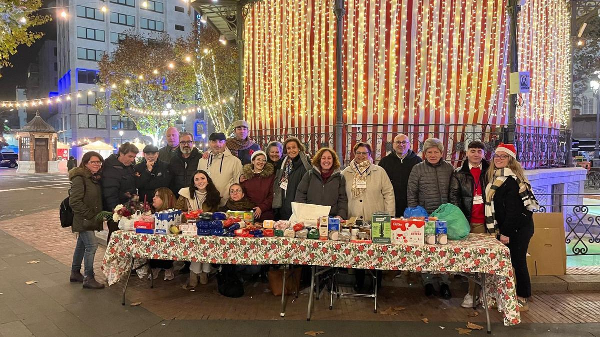 Cofradía del Santo Entierro junto a los alimentos recogidos en la edición anterior en San Francisco