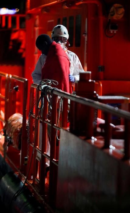 A migrant waits to disembark from a Spanish ...